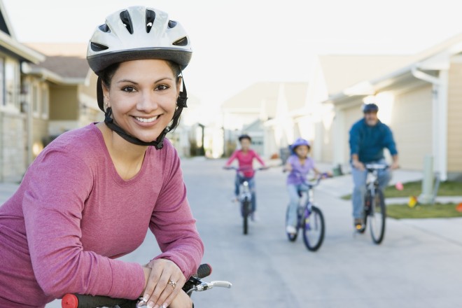 Woman riding bicycle with family